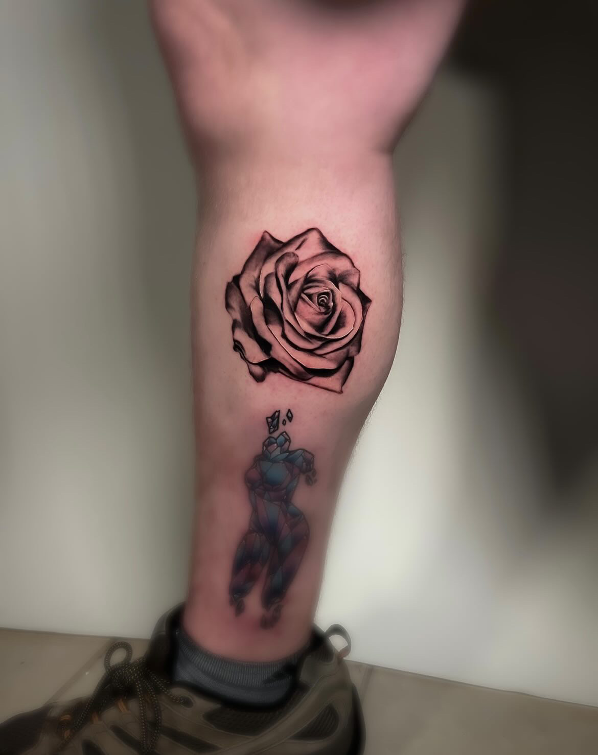 Fine line rose tattoo on a calf by tattoo artist Alessandra Clivio.